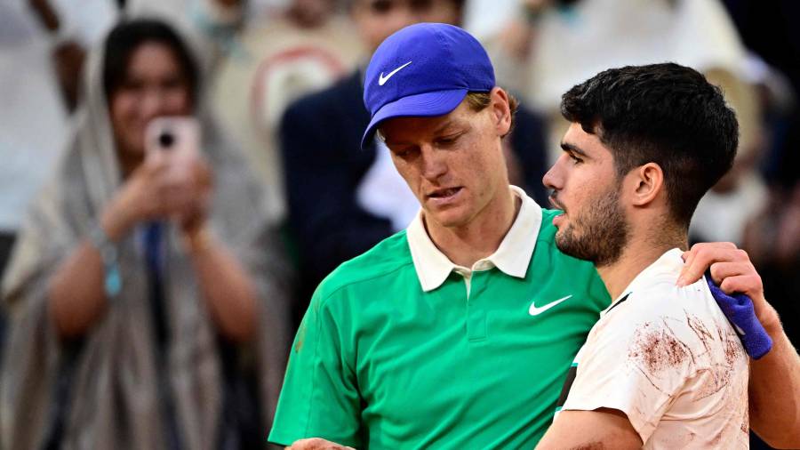 $![Winner Spain's Carlos Alcaraz (R) cheers Italy's Jannik Sinner at the end of their men's singles]