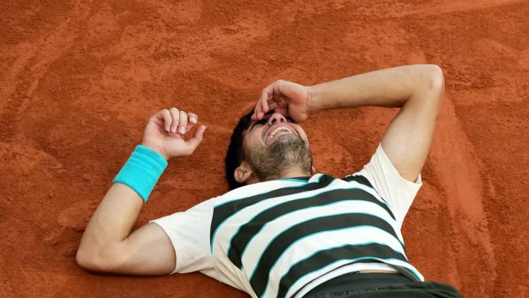 Spain's Carlos Alcaraz celebrates after winning the men's singles final match against Italy's Jannik Sinner on day 15 of the French Open tennis tournament on Court Philippe-Chatrier at the Roland-Garros Complex in Paris on June 8, 2025. (Photo by Dimitar DILKOFF / AFP)