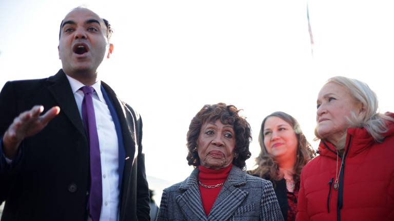 WASHINGTON, DC - JANUARY 21: (L-R) Former Director of the Consumer Financial Protection Bureau Rohit Chopra speaks as U.S. Rep. Maxine Waters (D-CA) and Rep. Sylvia Garcia (D-TX) looks on in front of the U.S. Supreme Court on January 21, 2026 in Washington, DC. The Supreme Court heard oral arguments today in Trump v. Cook. This landmark case centers on President Donald Trump's attempt to fire Federal Reserve Governor Lisa Cook, testing the legal boundaries of presidential power and the independence of the central bank. Alex Wong/Getty Images/AFP (Photo by ALEX WONG / GETTY IMAGES NORTH AMERICA / Getty Images via AFP)