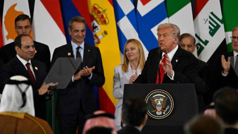 US President Donald Trump (C) delivers a statement during a summit on Gaza in Sharm el-Sheikh on October 13, 2025. Trump landed in Egypt on October 13 for a summit on Gaza, following a lightning visit to Israel after a ceasefire he brokered entered into force. (Photo by Khaled DESOUKI / AFP)