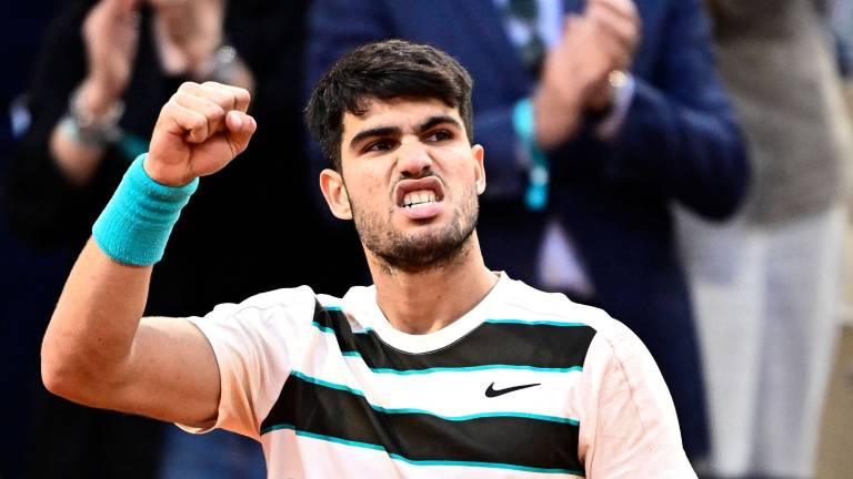 Spain's Carlos Alcaraz reacts after winning a game during his men's singles final match against Italy's Jannik Sinner on day 15 of the French Open tennis tournament on Court Philippe-Chatrier at the Roland-Garros Complex in Paris on June 8, 2025. (Photo by JULIEN DE ROSA / AFP)