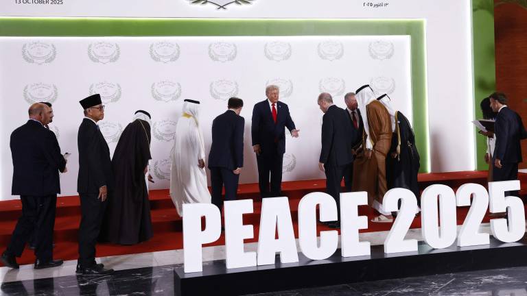 US President Donald Trump (C) welcomes leaders prior to a family picture during the greetings ceremony at the Gaza Peace Summit in Sharm El-Sheikh, on October 13, 2025. Trump landed in Egypt on October 13 for a summit on Gaza, following a lightning visit to Israel after a ceasefire he brokered entered into force. (Photo by Yoan VALAT / POOL / AFP)