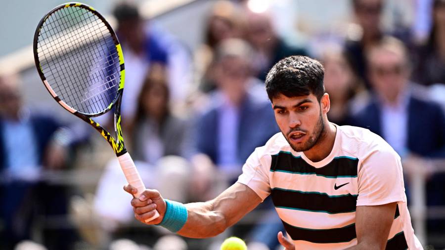 $![Spain's Carlos Alcaraz eyes the ball as he plays a forehand return to Italy's Jannik Sinner during]
